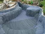 White of Witchampton - landscape gardener - Creating a water feature. The pond was lined with a protective blanket.