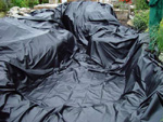 White of Witchampton - landscape gardener - Installing the pond liner.