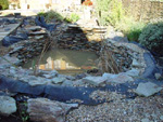 White of Witchampton - landscape gardener - We hide the pond liner behind rock walls and gravel.